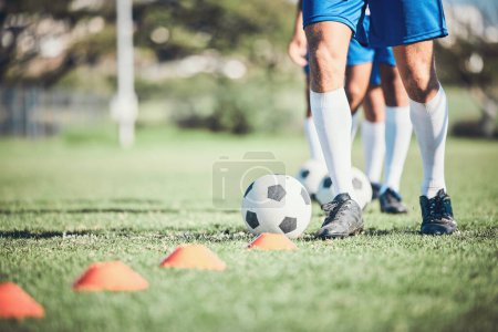 Photo for Feet, soccer player and ball with training cone on a field for sports game and fitness. Legs or shoes of male soccer or athlete person outdoor for agility, performance or workout on a grass pitch. - Royalty Free Image