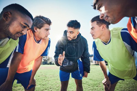 Photo for Coaching, football circle and people talking for sports teamwork, competition strategy and game on field. Listening, speaking and man, soccer player team or group motivation, goals or training advice. - Royalty Free Image