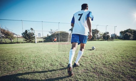 Photo for Sports, penalty and soccer player score a goal at training, game or match at a tournament. Fitness, exercise and back of a male football athlete kicking a ball at practice on outdoor field at stadium. - Royalty Free Image
