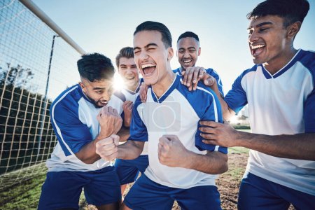 Photo for Winning, goal and soccer player with team and happiness, men play game with sports and celebration on field. Energy, action and competition with male athlete group, cheers and diversity with success. - Royalty Free Image