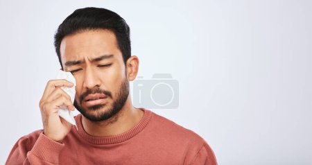 Photo for Crying, depression and sad asian man in studio with tissue, crisis or broken heart on grey background. Stress, mistake and face of male with tears for anxiety, trauma or bad news, fail or mourning. - Royalty Free Image