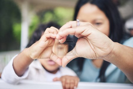 Photo for Mother, child and heart hands for love, care or compassion together in the outdoors. Mom and little kid putting hand for loving emoji, like or sign gesture for support, trust or parenting outside. - Royalty Free Image