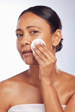 Photo for Skincare, senior or woman portrait with cotton pad for dermatology, wellness or healthy facial skin. Studio background, glow or face of mature person with swab for beauty, cleansing or dirt removal. - Royalty Free Image