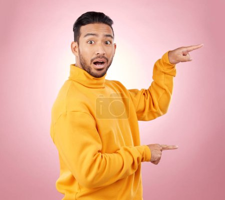 Photo for Surprise, pointing and wow with portrait of man in studio for show, announcement and deal. News, advertising and idea with person on pink background for promotion, information and solution mockup. - Royalty Free Image