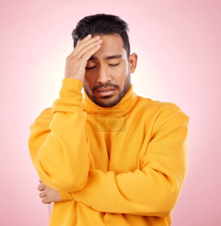 Photo for Stress, headache and asian man in studio with depression, broken heart or brain fog on pink background. Anxiety, migraine and Japanese guy in crisis, mistake or fail, vertigo or frustrated by trauma. - Royalty Free Image