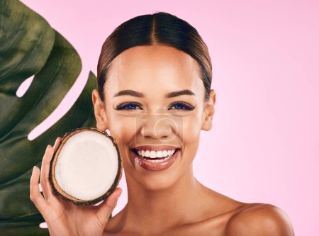 Photo for Fruit, coconut and portrait of woman with skincare, beauty and cosmetics for natural or vegan facial care, dermatology or treatment. Smile, happy and healthy girl with product, cream or moisturizer. - Royalty Free Image