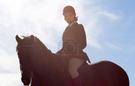 Photo for Equestrian, lens flare and portrait of woman on horse for competition, training and show. Performance, riding and fitness with female jockey on stallion for animal, athlete and contest event. - Royalty Free Image