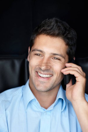 Photo for No, you hang up. Shot of a handsome young businessman talking on his cellphone against a black background - Royalty Free Image
