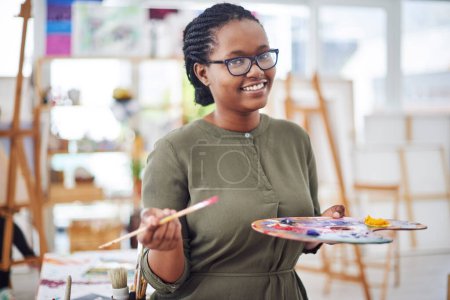 Photo for You are a work of art. Cropped shot of a young woman holding an artists palette in a art studio - Royalty Free Image