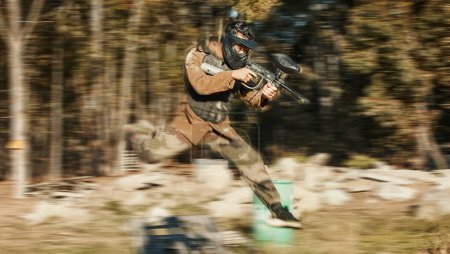Photo for Paintball, shooting and jump with man in playground for battlefield, mission and soldier. Sports, games and fast with person and gun gaming in arena for challenge, adventure and warrior training. - Royalty Free Image