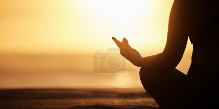 Photo for Silhouette, mockup and person doing meditation at the beach for wellness, health and zen or spiritual in morning sunrise. Balance, shadow and athlete meditate or yoga to be calm, workout and healthy. - Royalty Free Image