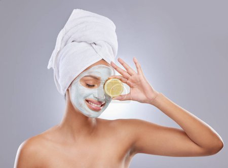Photo for Mask, skincare and lemon with woman in studio for beauty, natural cosmetics and vitamin c. Self care, glow and spa with face of female model and citrus fruit on grey background for detox product. - Royalty Free Image