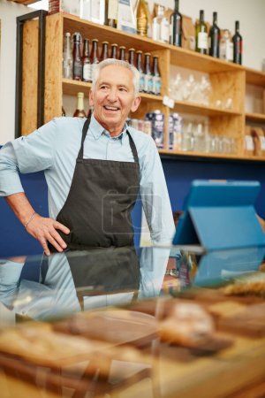 Photo for Hes got big plans for his small business. Shot of a senior man working in a bakery - Royalty Free Image