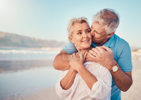 Photo for Beach, love and senior couple with a kiss in nature, holiday or romantic outdoor date together at the ocean or sea. Happy, smile on face and people in a hug, embrace or happiness on anniversary. - Royalty Free Image