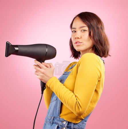 Photo for Hairdryer, beauty and hair care with portrait of woman in studio for hairdresser, salon and cosmetics. Shampoo, spa and hairstyle with face of asian person on pink background for product. - Royalty Free Image