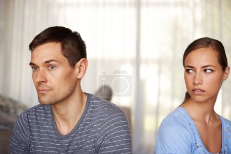 Photo for If he only knew. Shot of a young couple having a disagreement at home - Royalty Free Image