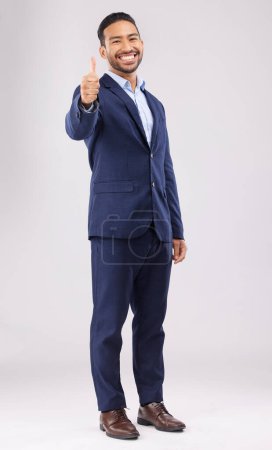 Photo for Happy businessman, portrait and thumbs up for approval, success or winning against a white studio background. Asian man smile with like emoji, yes sign or good job for business agreement or thank you. - Royalty Free Image