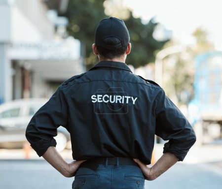 Photo for Man, back and security guard in city for safety protection, law enforcement or outdoor emergency. Rear view of male person, police or officer standing ready for crime control to protect and serve. - Royalty Free Image