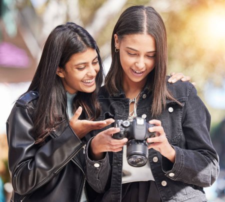 Photo for Photography camera, city and happy friends check photo, picture or urban photographer, women or tourist shooting. Creative photoshoot, sidewalk and gen z youth, students or young people analyse shot. - Royalty Free Image