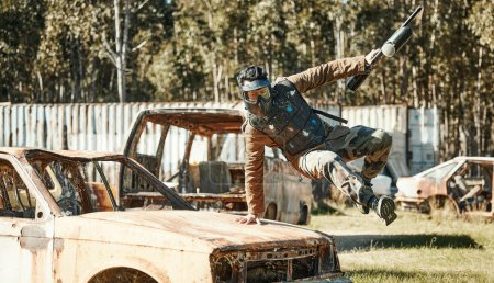 Photo for Paintball game, action and man jump car, agile and run in active battlefield, military playground or training arena. Army mission, gear and person in match competition, conflict or survival challenge. - Royalty Free Image