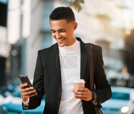 Photo for Business man, phone and texting in a city with social network and smile in the morning with commute. Happy, mobile networking and online app search with coffee and travel on urban street with typing. - Royalty Free Image
