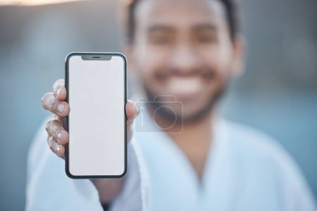 Photo for Sports, fitness mockup or happy man with phone for karate tips, fighting info or martial arts promo code. Portrait blur, screen or mma fighter with mobile app in healthy workout, exercise or training. - Royalty Free Image