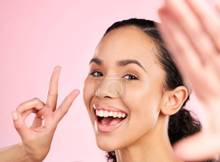 Photo for Selfie, peace sign and happy woman in studio with natural beauty, wellness and cosmetics. Portrait, female person and pink background with makeup and face with skincare and emoji hand gesture of girl. - Royalty Free Image