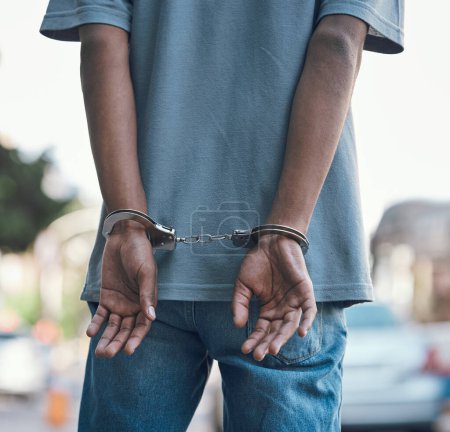 Hands, handcuffs and man criminal in city arrested for crime, corruption or justice with jail. Security, law and back of male prisoner, thief or gangster, prison or robbery, violence or murder fail.