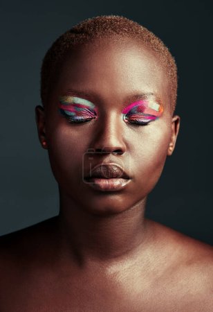 Photo for Who needs black and white when you can shine in color. Cropped shot of a beautiful woman wearing colorful eyeshadow while posing against a grey background - Royalty Free Image