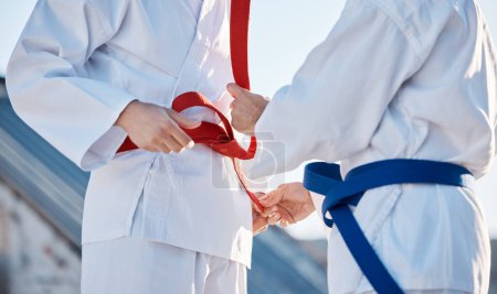 Photo for Karate, belt and people outdoor for training, workout or fitness achievement in city. Martial arts, sports and coach with student for taekwondo competition, battle and challenge to fight or exercise. - Royalty Free Image