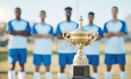 Photo for Soccer team, trophy and sports tournament for winning challenge, teamwork or event on the field outdoors. Gold award, championship or prize with group standing ready in football competition or league. - Royalty Free Image