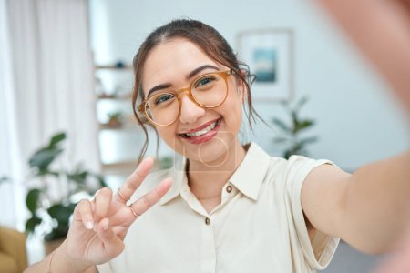 Photo for Woman, smile in selfie with peace hand sign, emoji and social media influencer with post or live streaming. Young female person, gen z and happy posing in picture, memory and content creation. - Royalty Free Image