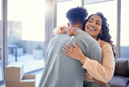 Photo for Happy couple, hug and real estate with key for new home, moving in or mortgage loan together indoors. Woman hugging man with smile in happiness, property or investment with keys to apartment building. - Royalty Free Image