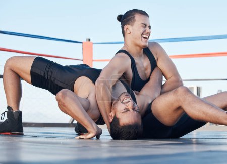 Men, wrestling and competition in a ring, mat or athlete winning in a tournament, match or training on floor of an arena. Fighting, match or championship gym with people grappling together for sport.