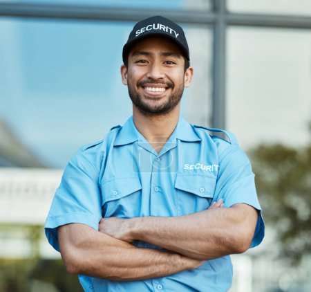 Photo for Asian man, portrait and security guard with arms crossed in city for career safety or outdoor protection. Male person, police or officer smile in confidence, law enforcement or patrol in urban town. - Royalty Free Image