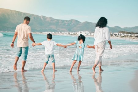 Photo for Hand holding, family is walking on beach and back view with ocean waves, summer and bonding in nature. Parents, children and people outdoor on holiday, freedom and travel, trust and love in Mexico. - Royalty Free Image
