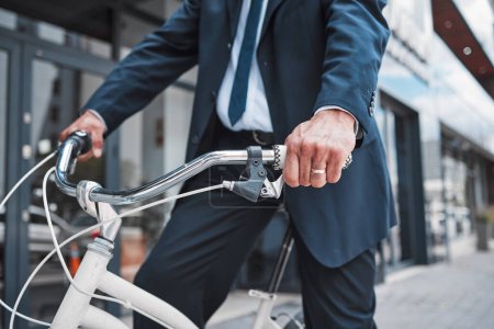 Photo for Hands, bicycle and businessman cycling in the city or riding for eco friendly travel, transport or commute to office, building or work. Man, driving and bike for carbon neutral footprint in town. - Royalty Free Image