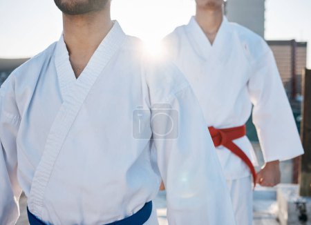 Photo for Karate, gi and men in city for training, workout and start exercise with lens flare. Martial arts, sport and people in competition for taekwondo, battle or fight challenge for healthy body in fitness. - Royalty Free Image