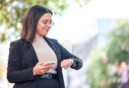 Photo for Professional, woman and checking time in outdoor for meeting at office with cellphone for appointment. Schedule, planning and professional female looking at watch in city before interview in street - Royalty Free Image