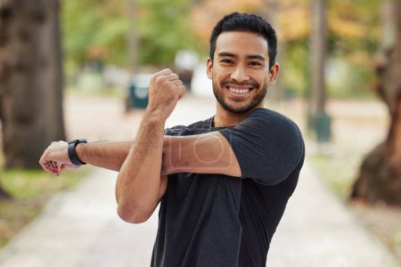 Photo for Happy asian man, portrait and stretching arms in fitness getting ready for running, workout or exercise at the park. Male person or runner with smile in warm up arm stretch, training or run in nature. - Royalty Free Image