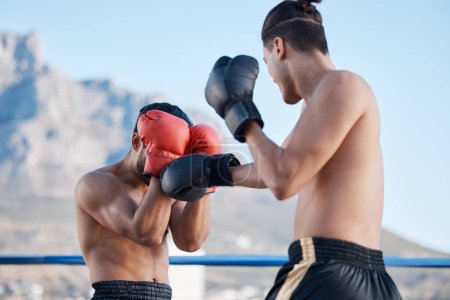 Photo for Punch, boxing match or men in sports training, exercise or fist punching with strong power in workout. Fitness, boxers or combat athletes fighting in a mma practice match in ring on rooftop in city. - Royalty Free Image