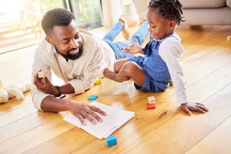 Photo for African dad, girl and floor for drawing, paper and learning together with smile, love and care in lounge. Black man, daughter and teaching with toys, notebook and helping hand in happy family house. - Royalty Free Image