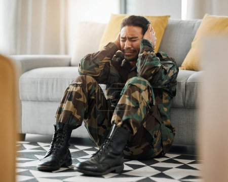 Photo for Soldier, sad and ptsd with man in living room for depression, stress and psychology. Army, military and war veteran with person and trauma at home for mental health, bipolar and schizophrenia problem. - Royalty Free Image