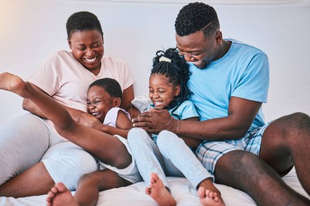 Photo for Laugh, black family and tickle in a bed with smile, care and happy on the weekend in their home. People, playing and children with parents in bedroom with games and having fun in the morning together. - Royalty Free Image
