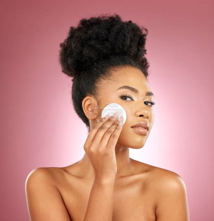 Photo for Black woman, cotton pad and portrait with makeup, dermatology and skincare on a studio background. Female person, shine and model with cosmetics, aesthetic and cleaning with beauty, glow and patches. - Royalty Free Image