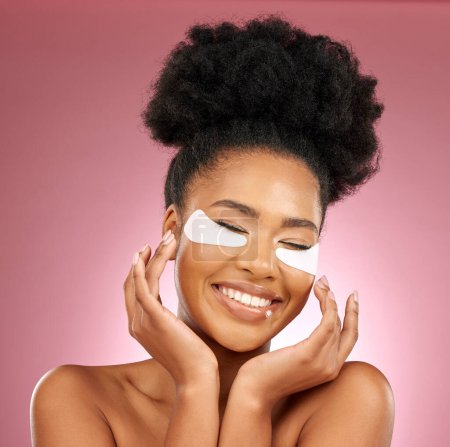 Photo for Skincare, happiness and black woman with mask on eyes, cosmetics and dermatology on pink background. Beauty, collagen product and model eye patches for healthy skin glow, smile and care in studio - Royalty Free Image