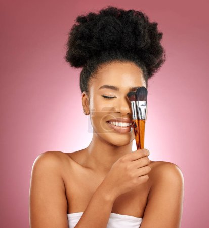 Photo for Makeup, smile and black woman with brushes, facial and dermatology against a studio background. Female person, aesthetic and happy model with cosmetic tools, natural beauty and grooming with skincare. - Royalty Free Image