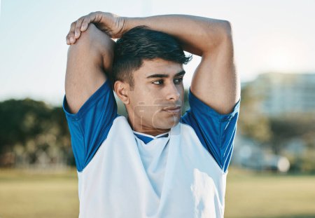 Photo for Man, soccer field or football player stretching arms thinking of training, exercise or workout in Brazil. Fitness, warm up or male athlete ready to start practice match or sports game in stadium. - Royalty Free Image