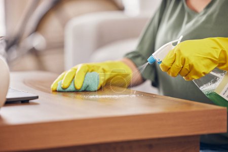 Photo for Hands, gloves and cleaning service a table in a home with safety from germs or dirt. Cleaner, dust and rubber protection with spray for household maintenance with a woman in a clean apartment. - Royalty Free Image