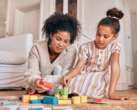 Photo for Family, education and building blocks with a daughter learning from her mother on the floor of their living room. Kids, growth and toys for child development with a woman teaching a girl at home. - Royalty Free Image
